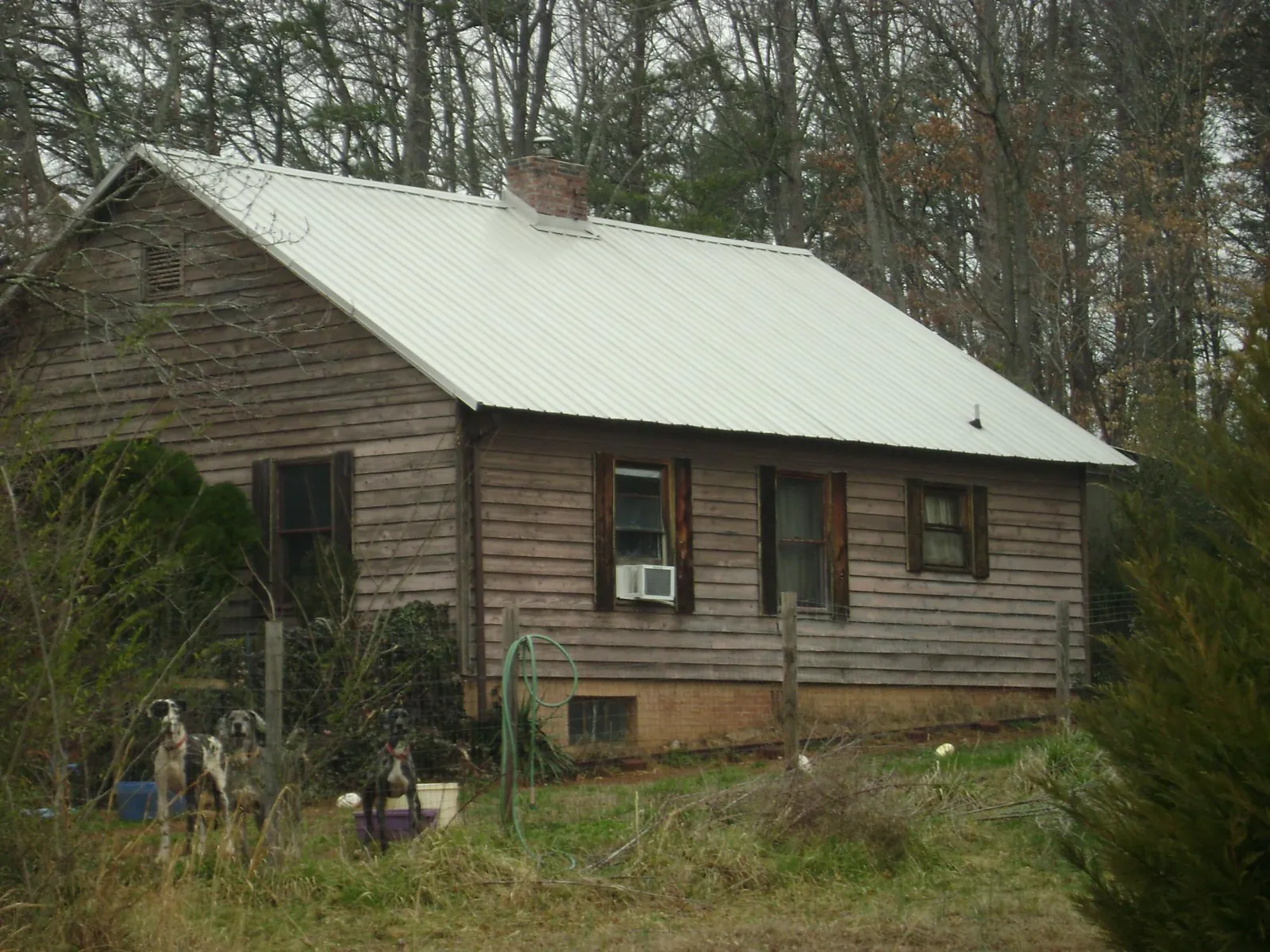 White metal roof on an old wood sided farmhouse, from a Metal Roof Installation job in Hanoverton